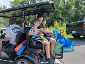 Heading for the pool in Uncle Alan and Aunt Liz's golf cart